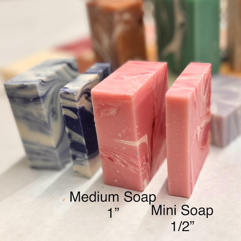 May include: Two bars of soap, one is a medium size and the other is a mini size. The medium soap is 1 inch and the mini soap is 1/2 inch. The medium soap is blue and white marbled and the mini soap is pink and white marbled.