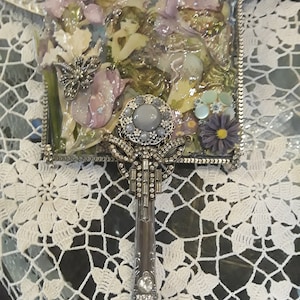 Vintage inspired hand mirror. Beautiful fairy image adorns this hand mirror, she's surrounded by butterflies dragonfly and flowers.
