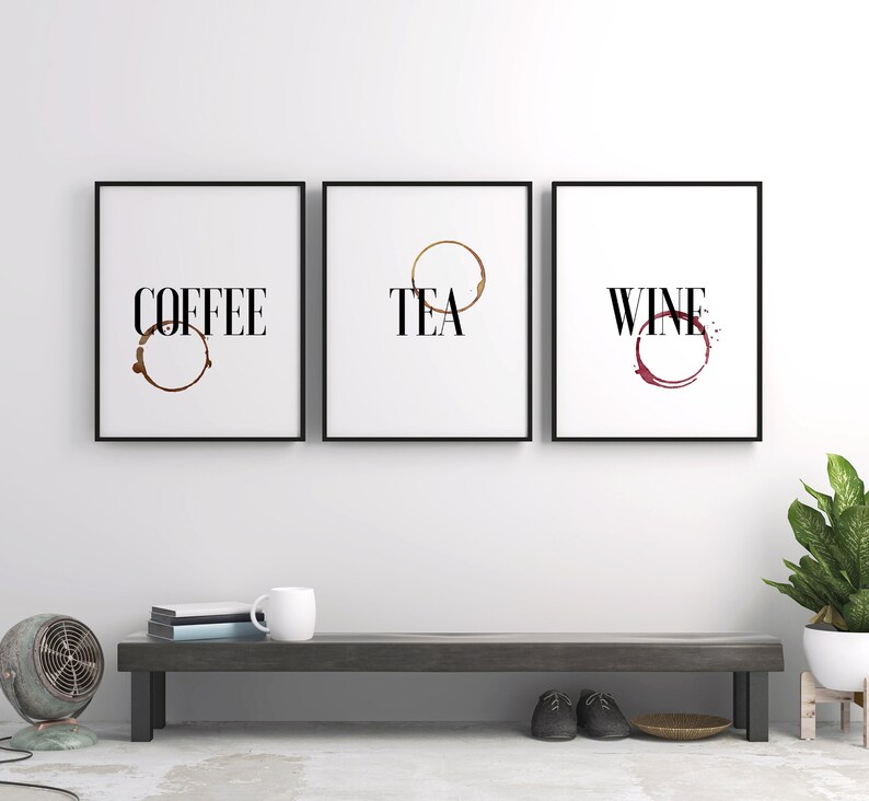 May include: Three black framed prints with white backgrounds and brown, gold, and red coffee, tea, and wine stains. The prints have the words "COFFEE", "TEA", and "WINE" printed in black.