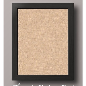 May include: A framed burlap print with a black frame. The burlap is a light beige color.