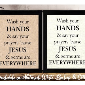 May include: Two framed signs with a burlap background and black frames. The signs have the text "Wash your HANDS & say your prayers 'cause JESUS & germs are EVERYWHERE" on them.