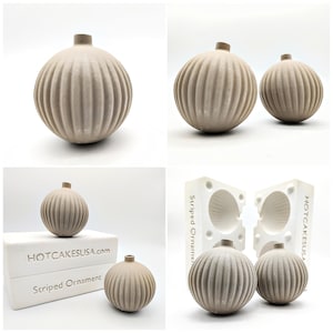 May include: Two gray, ribbed, round ornaments made from a silicone mold. The mold is labeled "Striped Ornament" and "HOTCAKESUSA.com".