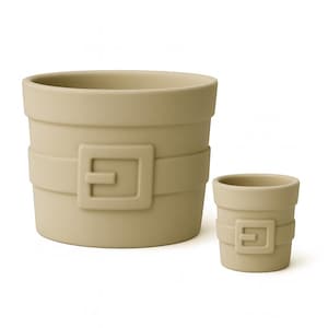 May include: Two beige ceramic planters, one large and one small, with a belt and buckle design. The larger planter is approximately 6 inches in diameter and 5 inches tall. The smaller planter is about 3 inches in diameter and 3 inches tall.