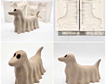 May include: Two ceramic ghost dog sculptures, one in a standing pose and the other in a lying down pose. The sculptures are a light brown color and have a smooth, matte finish.