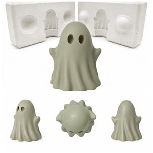May include: A sage green ghost figurine with two oval eye cutouts and a draped sheet appearance, shown from multiple angles alongside two white plaster mold halves featuring matching recessed ghost shapes and circular indentations.