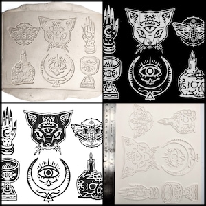 May include: A set of 10 silicone molds for making resin crafts. The molds feature various occult and mystical designs, including a cat with a third eye, a moth, a hand with an eye, a chalice, a bottle with a skull, and a crescent moon with an eye.