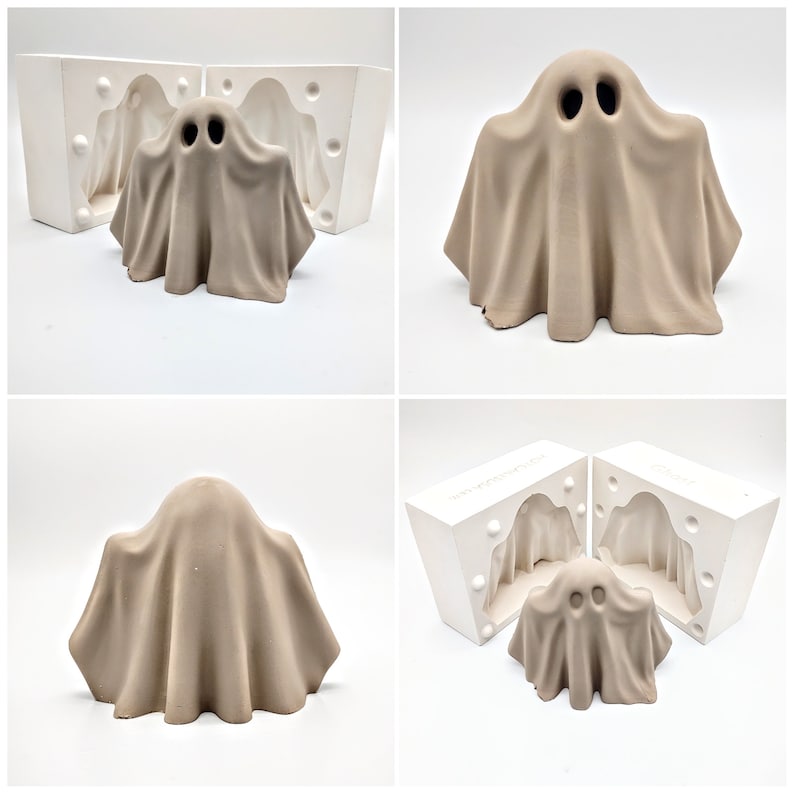 May include: Two white plaster molds for making a ghost-shaped ceramic figurine. The mold is open and a tan-colored ghost figurine is sitting inside the mold. The ghost has two black eyes.