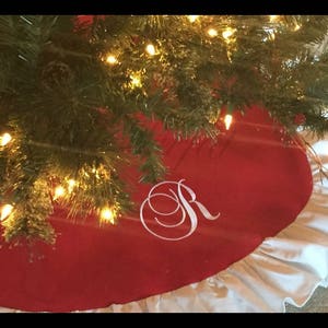 Handmade Christmas Tree Skirt in Red with white ruffled trim.