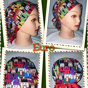 May include: A vibrant scrub cap with a repeating pattern of toy nutcracker soldiers in multiple colours. The cap has a red ribbon tie and is displayed on a mannequin head. The word "Euro" is visible in the image.