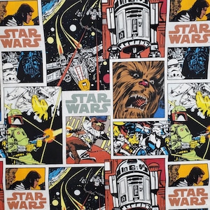 May include: A fabric panel with a comic strip design featuring Star Wars characters and scenes. The design includes Darth Vader, Chewbacca, R2-D2, X-wing fighters, and other elements from the Star Wars universe. The words "STAR WARS" are displayed in several panels.