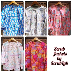 May include: Collection of scrub jackets in various patterns, including dogs, llamas, and fish. The jackets are displayed on wooden hangers. The text "Scrub Jackets by ScrubLub" is visible in the image.