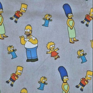 May include: A gray fabric with a repeating pattern of yellow cartoon characters. The characters include Homer Simpson, Bart Simpson, Lisa Simpson, Maggie Simpson, and Marge Simpson. The characters are all wearing their signature clothing and are in various poses.
