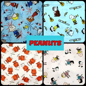 May include: Four different fabric patterns featuring Peanuts characters. The first pattern is blue with white fireworks and red firecrackers. The second pattern is blue with white musical instruments and characters. The third pattern is white with orange and white dog houses and the text "Snoopy" repeated. The fourth pattern is white with black and white characters ice skating.
