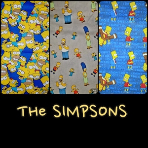 May include: Three fabric swatches with different designs featuring the Simpsons characters. The first swatch is blue with yellow Simpsons characters. The second swatch is beige with yellow Simpsons characters. The third swatch is blue with yellow Simpsons characters and the text 'I didn't do it' repeated in white.