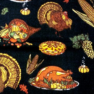May include: Thanksgiving-themed fabric with a dark blue background. The pattern features illustrations of turkeys, cornucopias filled with produce, corn, pumpkin pie, and a roasted turkey on a platter. The colors include shades of orange, yellow, and brown.