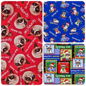 May include: A red, blue, and green fabric with a repeating pattern of a grumpy cat wearing a Santa hat. The cat is surrounded by Christmas lights and the text "Grumpy Cat" and "Bah Humbug!"