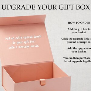 May include: A pink gift box with the text "Upgrade Your Gift Box" and instructions on how to add a personalized message inside the box.