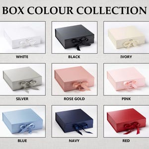 May include: A collection of nine square gift boxes with ribbon closures, labeled BOX COLOUR COLLECTION. Colors include white, black, ivory, silver, rose gold, pink, blue, navy, and red. Each box features a matching ribbon tied in a bow at the front.