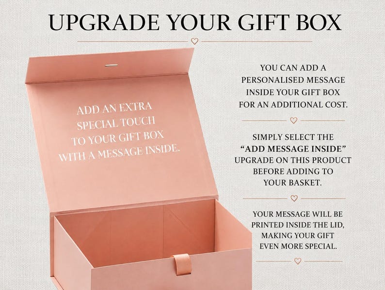 May include: A dusty pink rectangular gift box with a hinged lid and a magnetic closure. The interior of the lid features white text that reads: ADD AN EXTRA SPECIAL TOUCH TO YOUR GIFT BOX WITH A MESSAGE INSIDE. The box is open and empty.