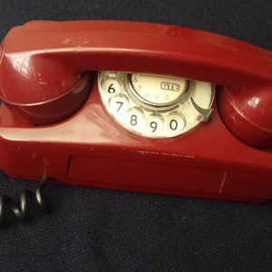Working red vintage telephone, manual telephone. landline telephone, rectangular telephone, retro telephone; vintage telephone.