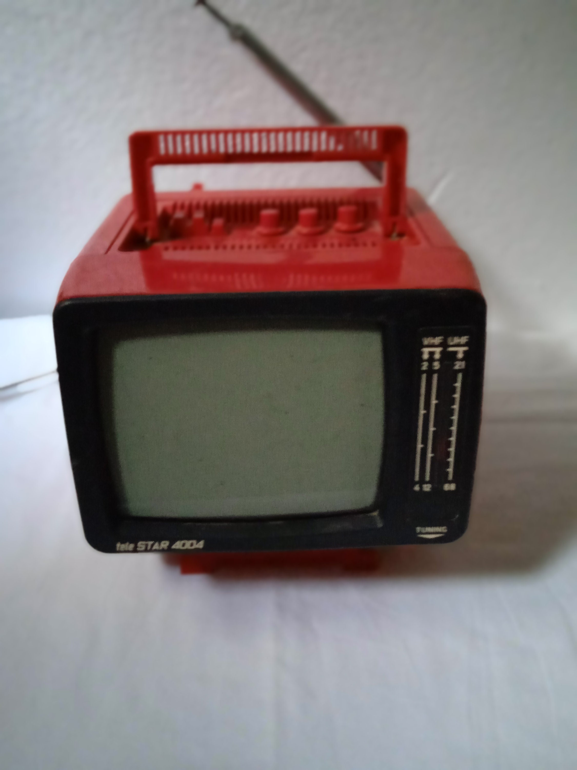 Premium Photo  Red retro old portable mini tv set with rotary telephone on  white background.