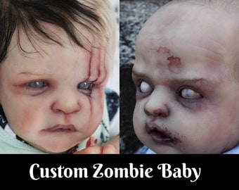 May include: Two custom-made zombie baby dolls with realistic details. One doll has a large gash on its forehead and the other has a small, round wound on its forehead. Both dolls have white eyes and a pale, grey complexion.