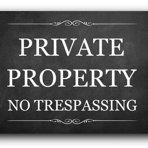 May include: Black and white sign with the text "PRIVATE PROPERTY NO TRESPASSING" on a black chalkboard background. The sign has a decorative border.
