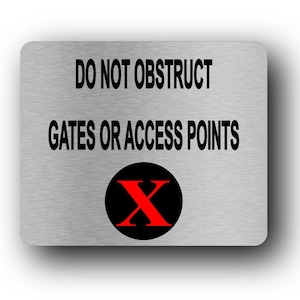 May include: A rectangular metal sign with rounded corners. The sign has the text "DO NOT OBSTRUCT GATES OR ACCESS POINTS" in black. A black circle with a red "X" is at the bottom. The sign has a brushed metal appearance.