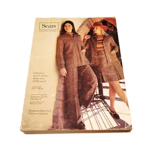 May include: Vintage Sears Fall and Winter catalog cover featuring two models in brown suits. One model wears a pantsuit, the other a skirt suit. The catalog cover has text that reads "everyday good values...every day of the year!" and "Simpsons-Sears Ltd. Toronto, Ontario."