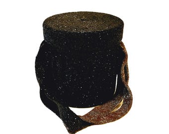 May include: A black beaded handbag with a round body and a long, beaded strap. The strap is a darker brown color than the bag.