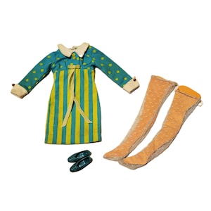 May include: A vintage doll outfit featuring a teal and yellow striped dress with a white collar and cuffs, teal polka dot sleeves, and a yellow bow. Includes orange knee-high socks and teal shoes. A retro fashion set.