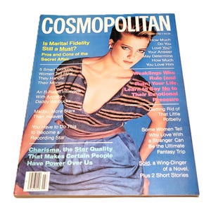 May include: A 1982 issue of Cosmopolitan magazine. The cover features a woman and a blue background with headlines such as "Is Marital Fidelity Still a Must?" and "How Much Do You Love Him?"