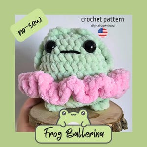 May include: A handmade crocheted frog ballerina in green and pink. The frog has large black eyes and a small mouth. It wears a pink tutu. The image includes the text "no-sew" and "crochet pattern digital download".