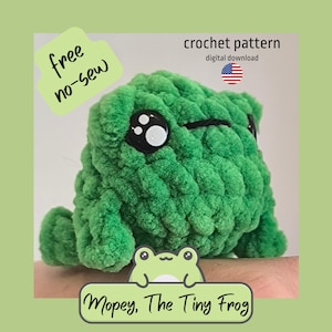 May include: A green crocheted frog plushie with large black and white eyes. The frog has a textured, fluffy appearance. Text on the image reads "free no-sew" and "Mopey, The Tiny Frog". The image also includes text that says "crochet pattern digital download".