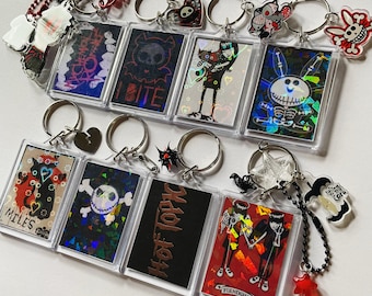 Early 2000s y2k holographic keychains emo charms Emily the strange skelanimals jack skull happy bunny hot topic band album cover goth