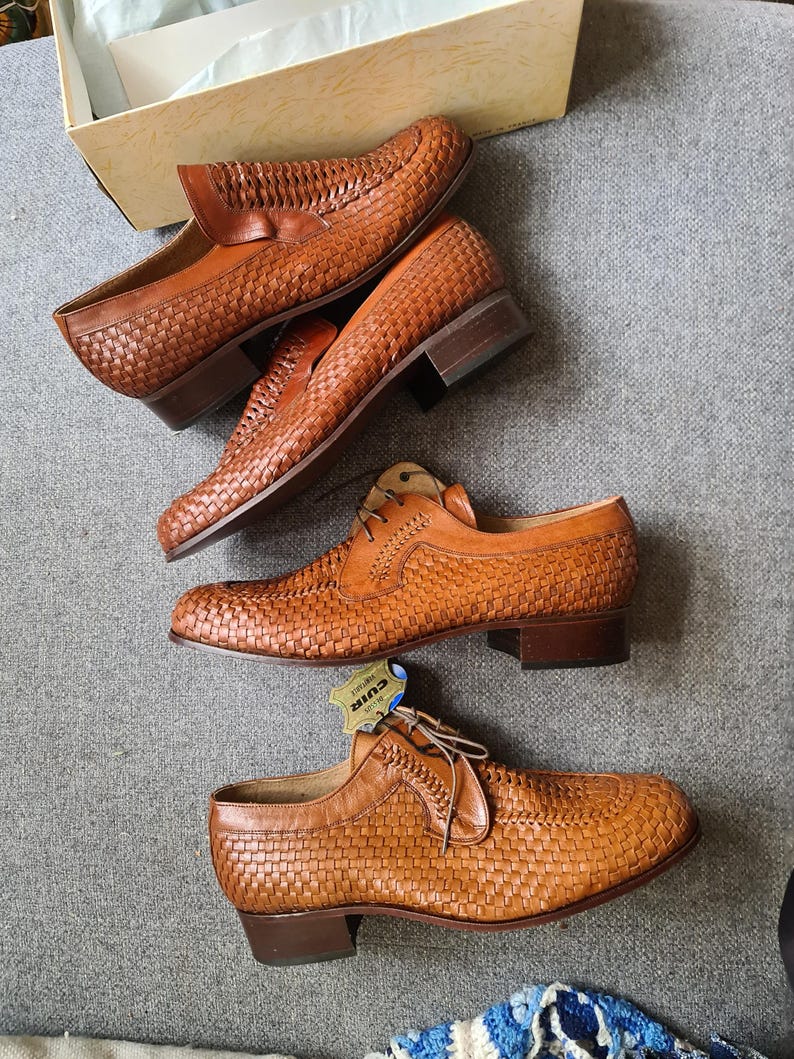 May include: Three pairs of brown leather woven shoes with a low heel. The shoes have a lace-up design and a woven leather upper. The shoes are in a new condition and are displayed on a grey surface.