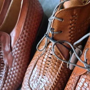 May include: Two pairs of brown leather woven shoes with laces. The shoes have a woven pattern and are made of a soft, supple leather.
