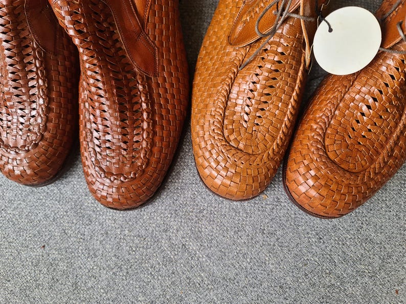 May include: Two pairs of brown leather woven shoes with a lace-up design.
