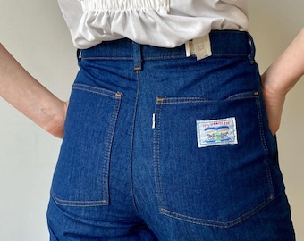 May include: A pair of dark blue denim jeans with a Levi Strauss & Co. patch on the back pocket.