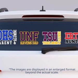 May include: Four car window decals with college-themed text. The decals read "DHS Parent & Alumni", "UNF Ravens Dad", "TSU Tiger Mom & Alumni", and "ERTU Auntie". The text is in various colors, including blue, purple, and red.