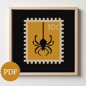 May include: Cross-stitch art of a postage stamp design featuring a black spider hanging from a thread. The stamp is yellow with the text "10c" and is set against a black background, framed in a wooden frame. A PDF logo is in the lower left corner.