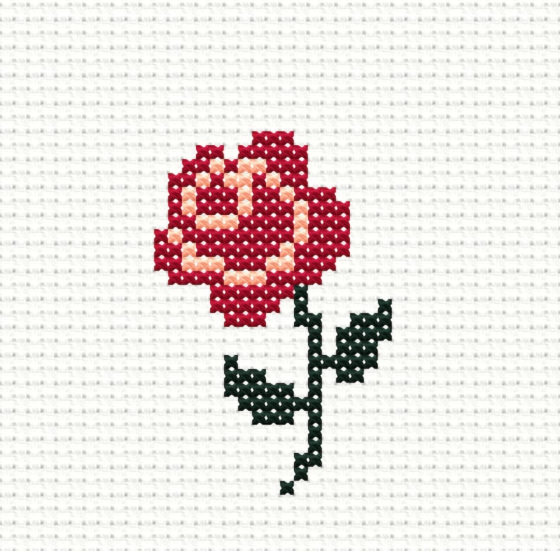 May include: A red and pink flower with a green stem and leaves. The flower is made of cross-stitched fabric.