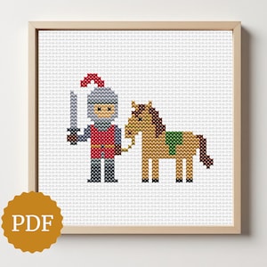 May include: Cross-stitch artwork of a knight holding a sword, standing next to a horse. The knight wears a red tunic, gray armor, and a helmet. The horse is brown with a green saddle. The artwork is framed in a light wood frame.