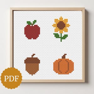 Puede incluir: Patrón de punto de cruz enmarcado en madera clara. La obra de arte presenta una manzana roja, un girasol amarillo, una bellota marrón y una calabaza naranja. El logotipo PDF está en la esquina inferior izquierda.