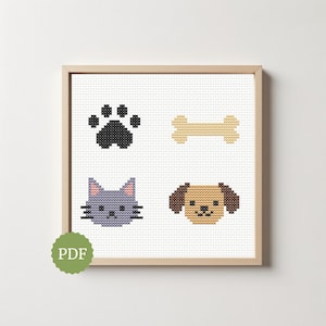 May include: Cross-stitch art print featuring a black paw print, a tan bone, a gray cat face, and a brown dog face. The artwork is displayed in a wooden frame. A green PDF logo is in the lower left corner.