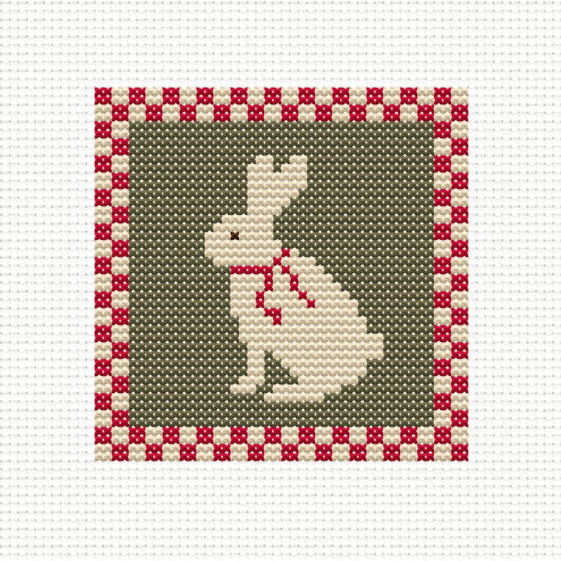 May include: A cross-stitch design featuring a cream-colored rabbit with a red bow tie, set against a muted green background. The design is framed by a red and white checkered border, creating a classic and charming aesthetic. The background is white.