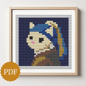 May include: Cross-stitch artwork depicting a cat with a pearl earring, inspired by Vermeer's "Girl with a Pearl Earring." The piece has a blue backdrop and is framed in wood. A PDF icon is visible in the bottom left corner.