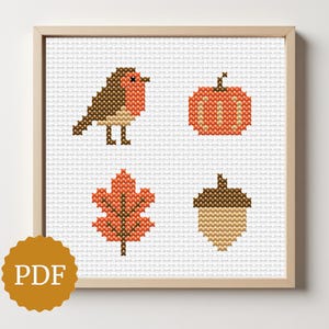 Op de afbeelding: Kruissteek kunstafdruk met een vogel, pompoen, blad en eikel in herfstkleuren. De afbeelding is ingelijst in een licht houten frame. Een gouden cirkel met de tekst 'PDF' staat linksonder.