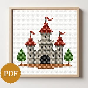 May include: Cross-stitch design of a grey castle with red-roofed towers and flags, framed in light wood. Two green trees flank the castle. The image includes a PDF logo.