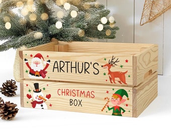 May include: A wooden Christmas box with a personalized name "Arthur's" and the words "Christmas Box". The box is decorated with festive illustrations of Santa Claus, a reindeer, a snowman, and an elf.